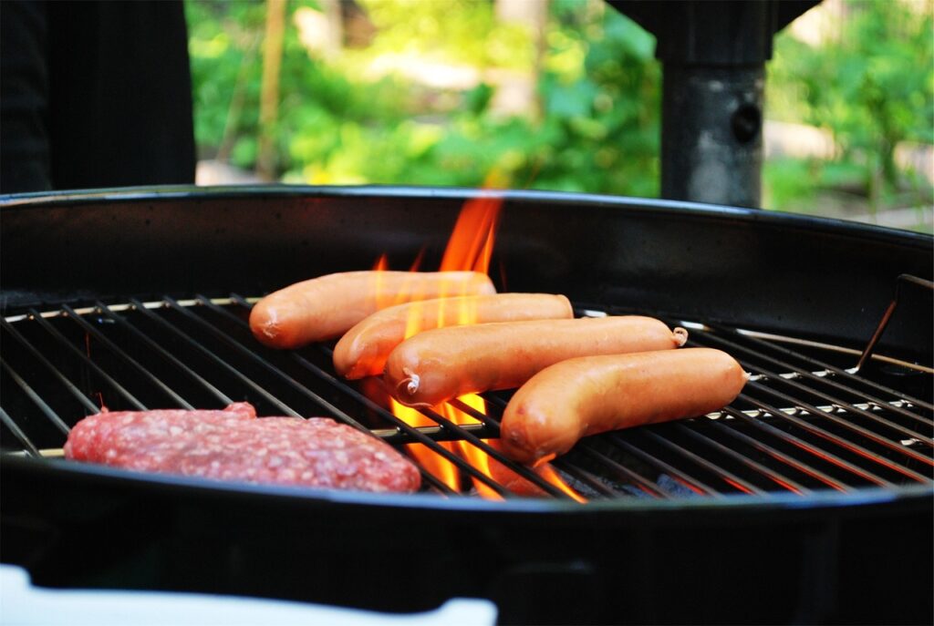 Photo of hamburger and hotdog on the bbq